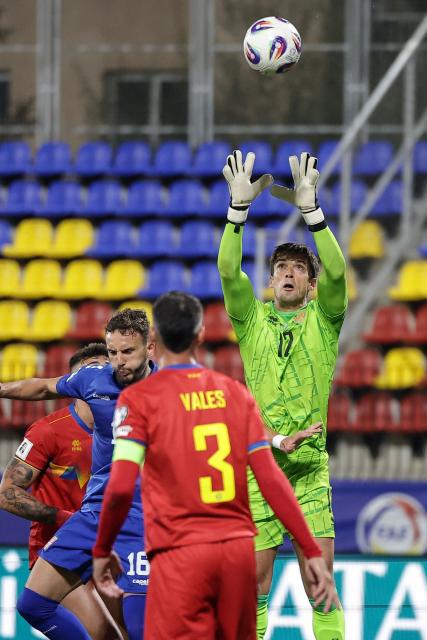 Andorra's goalkeeper #12 Iker Alvarez (R) catches the ball during the FIFA World Cup 2026 Group K European qualification football match between Andorra and Serbia, at the New FAF Stadium in Encamp, on October 14, 2025. (Photo by Valentine CHAPUIS / AFP)