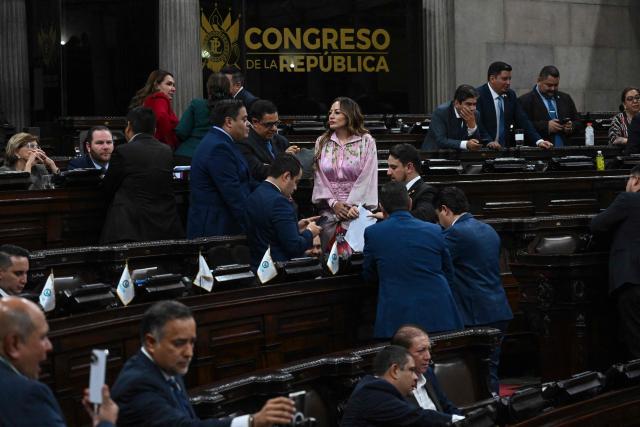 Guatemalan deputies take part in a session where they might review and approve an anti-gang law at the National Congress in Guatemala City on October 14, 2025. Twenty members of a gang designated a "foreign terrorist organization" by the United States have escaped from detention in Guatemala, a prison chief said Sunday. (Photo by JOHAN ORDONEZ / AFP)