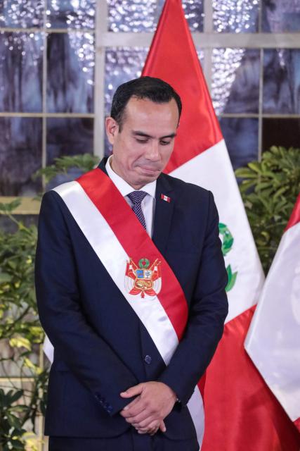 Peru's interim President Jose Jeri gestures during the inauguration ceremony of his cabinet at the Presidential Palace in Lima on October 13, 2025. Peru's new interim president, José Jerí, appointed a retired general who fought against the Shining Path guerrilla group as interior minister on Tuesday, one of the key positions in the transitional government. (Photo by CONNIE FRANCE / AFP)