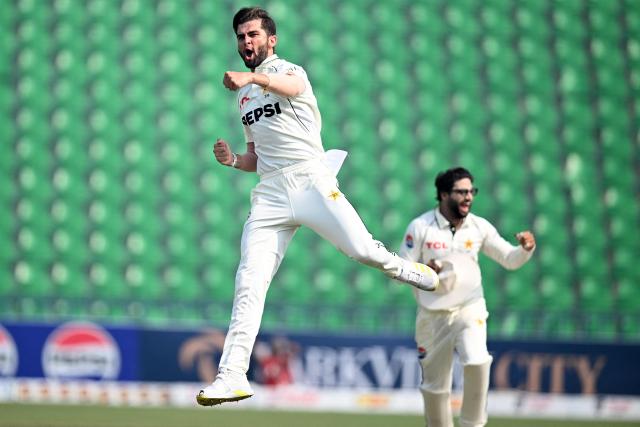 TOPSHOT - Pakistan's Shaheen Shah Afridi (L) celebrates after taking the wicket of South Africa's Tony de Zorzi during the fourth day of the first Test cricket match between Pakistan and South Africa at the Gaddafi Stadium in Lahore on October 15, 2025. (Photo by Aamir QURESHI / AFP)