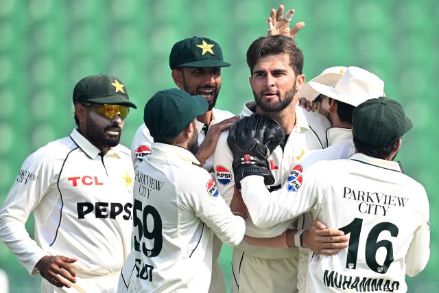 Pakistan's Shaheen Shah Afridi (3R) celebrates with teammates after taking the wicket of South Africa's Tony de Zorzi during the fourth day of the first Test cricket match between Pakistan and South Africa at the Gaddafi Stadium in Lahore on October 15, 2025. (Photo by Aamir QURESHI / AFP)