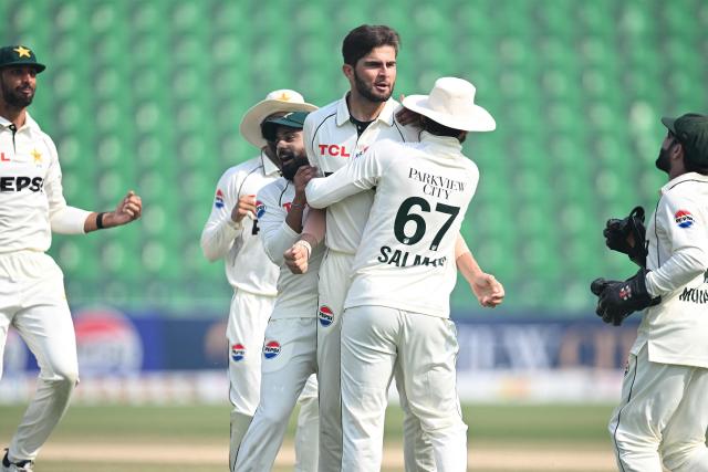 Pakistan's Shaheen Shah Afridi (C) celebrates with teammates after taking the wicket of South Africa's Tony de Zorzi during the fourth day of the first Test cricket match between Pakistan and South Africa at the Gaddafi Stadium in Lahore on October 15, 2025. (Photo by Aamir QURESHI / AFP)