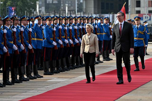 President of the European Commission Ursula von der Leyen inspects a guard of honour with Serbia's President Aleksandar Vucic prior to their meeting in Belgrade on October 15, 2025. (Photo by Andrej ISAKOVIC / AFP)