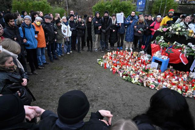 (FILES) People form a human-chain around a makeshift memorial for the victims of a knife attack, to prevent Bjoern Hoecke, AfD parliamentary group leader at the regional parliament in Thuringia from laying flowers there on January 24, 2025 in Aschaffenburg, western Germany. Nearly nine months after the fatal knife attack on daycare children in Aschaffenburg, the trial will begin on October 16, 2025 at the Bavarian city's regional court. The public prosecutor's office has accused a 28-year-old of murder and has applied for a so-called "preventive procedure." According to the court, an expert opinion concluded that the man, originally from Afghanistan, is not criminally responsible due to a psychiatric illness. The crime sparked widespread outrage and political debate. The man is said to have attacked a group of daycare children in a park in Aschaffenburg on January 22, 2025, stabbing a two-year-old boy and a man who tried to help the children. (Photo by Kirill KUDRYAVTSEV / AFP)