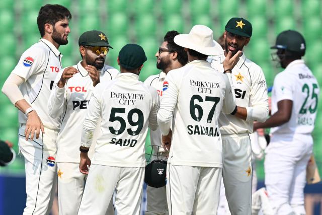 Pakistan's players celebrate after winning the first Test cricket match between Pakistan and South Africa at the Gaddafi Stadium in Lahore on October 15, 2025. (Photo by Aamir QURESHI / AFP)