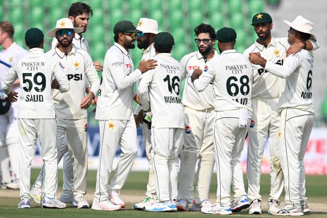 Pakistan's players celebrate after winning the first Test cricket match between Pakistan and South Africa at the Gaddafi Stadium in Lahore on October 15, 2025. (Photo by Aamir QURESHI / AFP)