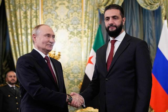 Russian President Vladimir Putin and Syrian interim president Ahmed al-Sharaa shake hands during their meeting at the Grand Kremlin Palace in Moscow on October 15, 2025. (Photo by Alexander Zemlianichenko / POOL / AFP)