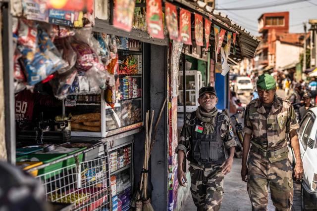 Members of Madagascars Army CAPSAT unit walk past a a commercial area near the CAPSAT base, a day after the unit announced it would assume power in Antananarivo, on October 15, 2025. Madagascar braced for a new era of military rule on October 15, 2025, a day after after an elite army unit seized power following President Andry Rajoelina's dramatic impeachment for desertion.
The CAPSAT military contingent assumed power Tuesday moments after parliamentarians voted overwhelmingly to impeach Rajoelina, who appeared to have fled the island nation as soldiers joined weeks of street protests at the weekend. (Photo by Luis TATO / AFP)