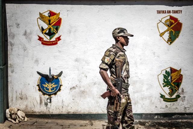 TOPSHOT - A member of Madagascars Army CAPSAT unit monitors the access to the CAPSAT base, a day after the unit announced it would assume power in Antananarivo, on October 15, 2025. Madagascar braced for a new era of military rule on October 15, 2025, a day after after an elite army unit seized power following President Andry Rajoelina's dramatic impeachment for desertion.
The CAPSAT military contingent assumed power Tuesday moments after parliamentarians voted overwhelmingly to impeach Rajoelina, who appeared to have fled the island nation as soldiers joined weeks of street protests at the weekend. (Photo by Luis TATO / AFP)