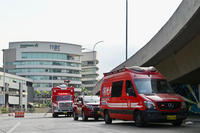 Guayaquil Fire Department vehicles remain at the site where a car bomb exploded the night before in front of a shopping center in northern Guayaquil, Ecuador, on October 15, 2025. One person died and several were injured after an explosion on Tuesday in a busy shopping area of the Ecuadorian port of Guayaquil, which was left in chaos, according to images released by local authorities. (Photo by MARCOS PIN / AFP)