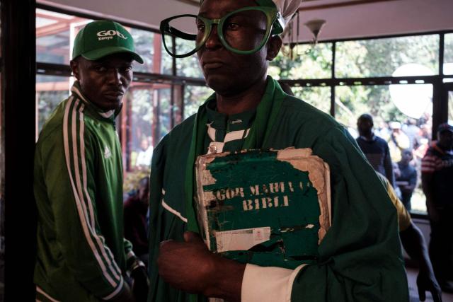 A supporter of Kenyan opposition leader Raila Odinga holds a book at Odinga's official residence in the Karen neighbourhood of Nairobi on October 15, 2025 as they demand information before the death of Raila Odinga was announced. Kenyan opposition leader Raila Odinga has died at the age of 80 during a health visit to India, local police said on October 15, 2025.
Odinga was the perennial opposition figure of Kenyan politics, running unsuccessfully for the presidency on five occasions, most recently in 2022. 
He remained a dominant force, able to rally huge numbers, particularly from his native western Kenya. (Photo by Kabir Dhanji / AFP)