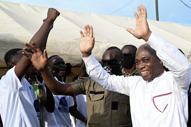 Independent presidential candidate Ahoua Don Mello waves to his supporters during a campaign rally at the commune of Port-Bouet in Abidjan on October 15, 2025. The west African nation will go to the polls on October 25 and incumbent Ouattara, in power since 2011, is vying for a fourth term in office. (Photo by Sia KAMBOU / AFP)
