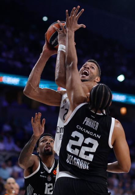 Real Madrid's French guard #12 Theo Maledon goes up for a shot as Partizan Belgrade's US forward #12 Sterling Brown and US forward #22 Jabari Parker defend during the Euroleague basketball match between Real Madrid Baloncesto and Partizan Belgrade at Movistar Arena in Madrid on October 15, 2025. (Photo by Oscar DEL POZO / AFP)