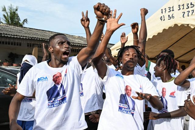 Supporters wearing T-shirts bearing images of Ivorian independent presidential candidate Ahoua Don Mello cheer during his campaign rally at the commune of Port-Bouet in Abidjan on October 15, 2025. The west African nation will go to the polls on October 25 and incumbent Ouattara, in power since 2011, is vying for a fourth term in office. (Photo by Sia KAMBOU / AFP)