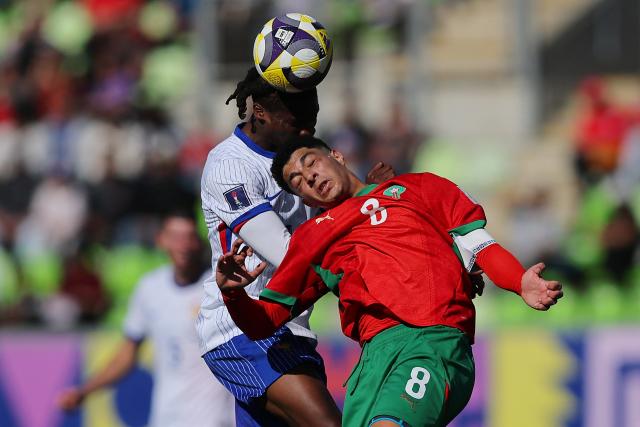 TOPSHOT - France's midfielder #19 Fode Sylla (L) and Morocco's midfielder #8 Houssam Essadak jump to head the ball during the 2025 FIFA U-20 World Cup semi-final football match between Morocco and France at the Elias Figueroa Stadium in Valparaiso, Chile on October 15, 2025. (Photo by Javier TORRES / AFP)