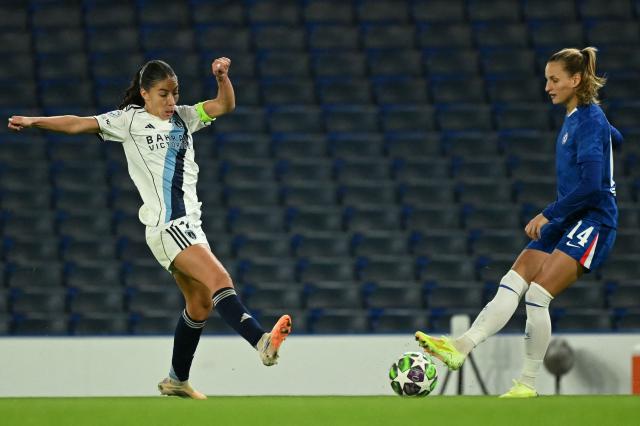 Paris FC's French striker #10 Clara Mateo (L) tries to tackle Chelsea's Swedish defender #14 Nathalie Bjorn (R) during the UEFA Women's Champions League, league phase football match between Chelsea and Paris FC at Stamford Bridge in London on October 15, 2025. (Photo by JUSTIN TALLIS / AFP)