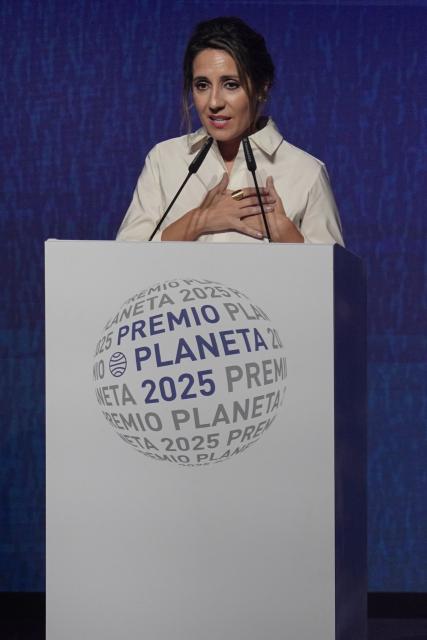 Finalist of Spain's 2025 Premio Planeta Award, Spanish writer Angela Banzas for her novel "Cuando el Viento Hable " (When the Wind Speaks), delivers a speech during the ceremony of the 74th edition of the "Premio Planeta" award at the National Art Museum of Catalonia in Barcelona on October 15, 2025. (Photo by Manaure Quintero / AFP)