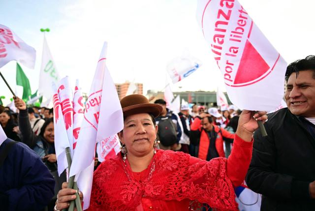 A supporter of Bolivia's presidential candidate for the Freedom and Democracy (Libre) Alliance, Jorge "Tuto" Quiroga attends his closing campaign rally in La Paz on October 15, 2025. An ex-president and a senator will go head-to-head in Bolivia's presidential runoff on October 19, 2025, both with promises to fix the South American country's broken economy. Senator Rodrigo Paz came from behind to take the top spot with 32 percent of votes cast in a first round in August, but has since fallen behind ex-president Jorge "Tuto" Quiroga in stated voter intention. (Photo by MARTIN BERNETTI / AFP)