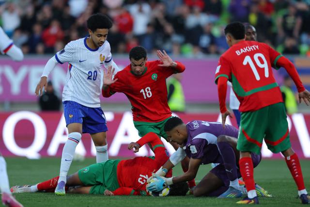 Morocco's goalkeeper #12 Ibrahim Gomis catches the ball past teammates forward #13 Taha Majni, midfielder #18 Yassine Khalifi, defender #19 Smail Bakhty, and France's forward #20 Djylian N'Guessan during the 2025 FIFA U-20 World Cup semi-final football match between Morocco and France at the Elias Figueroa Stadium in Valparaiso, Chile on October 15, 2025. (Photo by Javier TORRES / AFP)