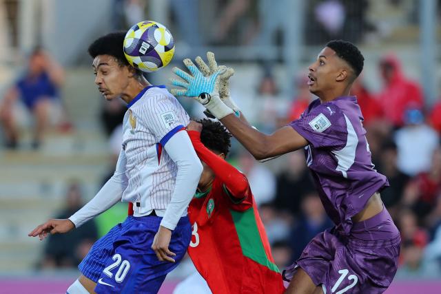 France's forward #20 Djylian N'Guessan heads the ball past Morocco's goalkeeper #12 Ibrahim Gomis during the 2025 FIFA U-20 World Cup semi-final football match between Morocco and France at the Elias Figueroa Stadium in Valparaiso, Chile on October 15, 2025. (Photo by Javier TORRES / AFP)