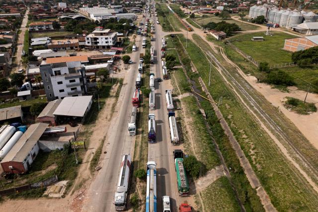 Aerial view of fuel tankers near a refinery in Santa Cruz, Bolivia on October 15, 2025. Bolivia will choose a president from among two right-wing candidates Sunday after two decades of socialist rule, with voters hoping for urgent measures to address foreign currency, fuel and food shortages. (Photo by Ernesto BENAVIDES / AFP)