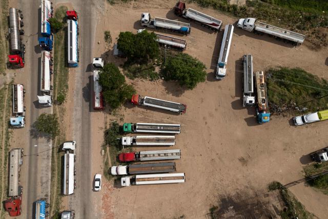 Aerial view of fuel tankers near a refinery in Santa Cruz, Bolivia on October 15, 2025. Bolivia will choose a president from among two right-wing candidates Sunday after two decades of socialist rule, with voters hoping for urgent measures to address foreign currency, fuel and food shortages. (Photo by Ernesto BENAVIDES / AFP)