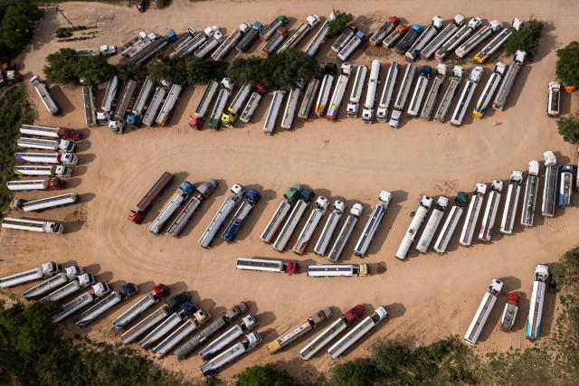 Aerial view of fuel tankers near a refinery in Santa Cruz, Bolivia on October 15, 2025. Bolivia will choose a president from among two right-wing candidates Sunday after two decades of socialist rule, with voters hoping for urgent measures to address foreign currency, fuel and food shortages. (Photo by Ernesto BENAVIDES / AFP)