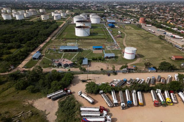 Aerial view of fuel tankers near a refinery in Santa Cruz, Bolivia on October 15, 2025. Bolivia will choose a president from among two right-wing candidates Sunday after two decades of socialist rule, with voters hoping for urgent measures to address foreign currency, fuel and food shortages. (Photo by Ernesto BENAVIDES / AFP)