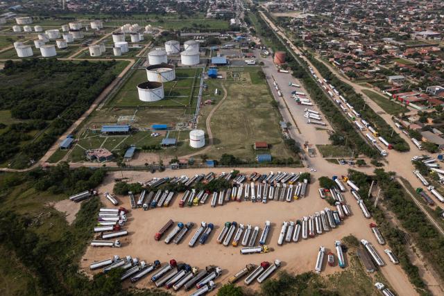 Aerial view of fuel tankers near a refinery in Santa Cruz, Bolivia on October 15, 2025. Bolivia will choose a president from among two right-wing candidates Sunday after two decades of socialist rule, with voters hoping for urgent measures to address foreign currency, fuel and food shortages. (Photo by Ernesto BENAVIDES / AFP)