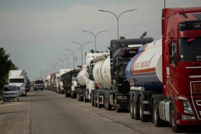 Fuel tankers queue up near a refinery in Santa Cruz, Bolivia on October 15, 2025. Bolivia will choose a president from among two right-wing candidates Sunday after two decades of socialist rule, with voters hoping for urgent measures to address foreign currency, fuel and food shortages. (Photo by ERNESTO BENAVIDES / AFP)