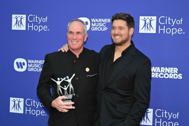 Canadian singer Michael Bublé (R) and Spirit of Life Honoree, Warner Records COO Tom Corson pose during the City of Hope's 2025 Spirit of Life Gala in Los Angeles, California, October 15, 2025. (Photo by Robyn Beck / AFP)