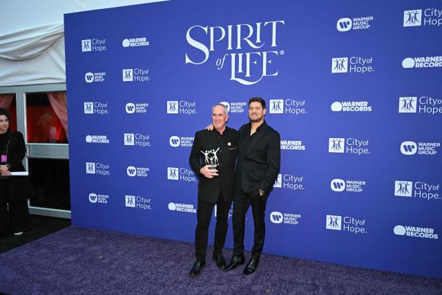 Canadian singer Michael Bublé (R) and Spirit of Life Honoree, Warner Records COO Tom Corson, pose for photos during the City of Hope's 2025 Spirit of Life Gala in Los Angeles, California, October 15, 2025. (Photo by Robyn Beck / AFP)