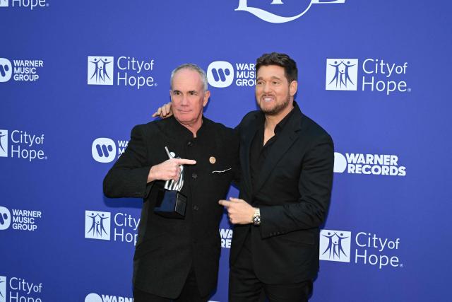 Canadian singer Michael Bublé (R) and Spirit of Life Honoree, Warner Records COO Tom Corson, pose for photos during the City of Hope's 2025 Spirit of Life Gala in Los Angeles, California, October 15, 2025. (Photo by Robyn Beck / AFP)