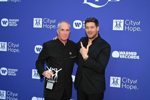 Canadian singer Michael Bublé (R) and Spirit of Life Honoree, Warner Records COO Tom Corson, pose for photos during the City of Hope's 2025 Spirit of Life Gala in Los Angeles, California, October 15, 2025. (Photo by Robyn Beck / AFP)