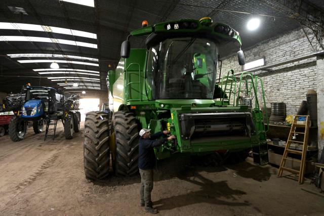 An employee of "Guanzini Hermanos S.A." checks a combine sprayer at Cucullu, a small town near the rural town of San Andres de Giles in Buenos Aires province, Argentina on September 24, 2025. Surrounded by wheat fields and dozing during siesta time, the farming town of San Andres de Giles voted for Javier Milei in 2023. Two years later, the enthusiasm has faded into disappointment and uncertainty, ahead of a crucial legislative election for the Argentine president. (Photo by JUAN MABROMATA / AFP)