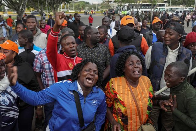 Supporters and mourners of Kenyan opposition leader Raila Odinga react at the Jomo Kenyatta International Airport (JKIA) in Nairobi on October 16, 2025 ahead of the arrival of Odinga's body following his death at the age of 80 during a health visit to India. Kenyan opposition leader Raila Odinga has died at the age of 80 during a health visit to India, local police said on October 15, 2025.
Odinga was the perennial opposition figure of Kenyan politics, running unsuccessfully for the presidency on five occasions, most recently in 2022. 
He remained a dominant force, able to rally huge numbers, particularly from his native western Kenya. (Photo by Tony Karumba / AFP)