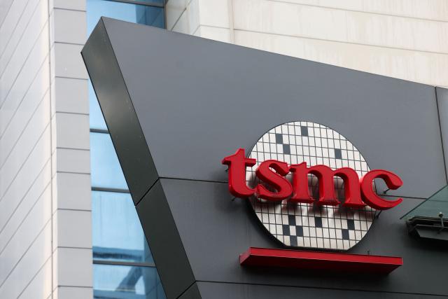 (FILES) The logo of Taiwan Semiconductor Manufacturing Company (TSMC) is seen at its headquarters in Hsinchu on November 21, 2024. Taiwanese tech titan TSMC reported on October 16, 2025 a forecast-busting net profit for the third quarter on skyrocketing demand for semiconductor chips used to power iPhones and artificial intelligence. (Photo by I-Hwa CHENG / AFP)