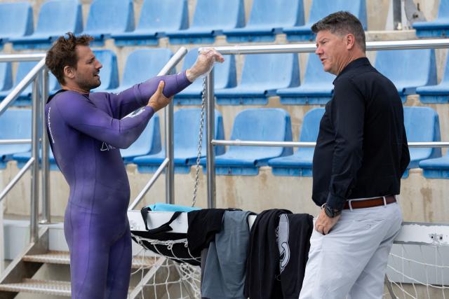 Croatian free diver Vitomir Maricic, 40, (L) talks to his friend and doctor Igor Barkovic, pulmologist and expert in hyperbaric and maritime medicine at the pool in Rijeka, on October 14, 2025. Croatian freediver Vitomir Maricic went beyond what seemed impossible for the human body by holding his breath for an astonishing 29 minutes and three seconds under water. (Photo by DAMIR SENCAR / AFP)