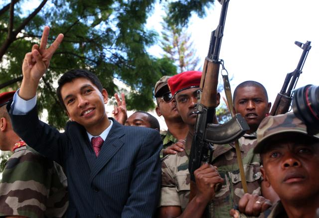 (FILES) (FILES) Madagascar opposition leader Andry Rajoelina (C) gives the V for victory sign as he parades through the streets of Antananarivo on March 17, 2009. Madagascar's ousted president confirmed for the first time that he had fled the country, issuing a statement after a military-led power grab prompted by weeks of demonstrations that have plunged the island nation into crisis.
President Andry Rajoelina left between October 11 and 12 after "explicit and extremely serious threats were made against the life of the Head of State," the presidency said in a statement late Wednesday. (Photo by ALEXANDER JOE / AFP)