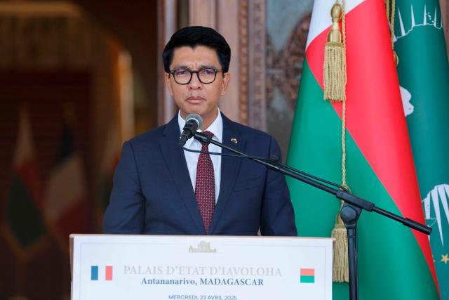 (FILES) Madagascar's President Andry Rajoelina speaks during a joint press conference with unseen France's President Emmanuel Macron (L) at the Presidential Palace in Antananarivo on April 23, 2025. Madagascar's ousted president confirmed for the first time that he had fled the country, issuing a statement after a military-led power grab prompted by weeks of demonstrations that have plunged the island nation into crisis.
President Andry Rajoelina left between October 11 and 12 after "explicit and extremely serious threats were made against the life of the Head of State," the presidency said in a statement late Wednesday. (Photo by Ludovic MARIN / POOL / AFP)