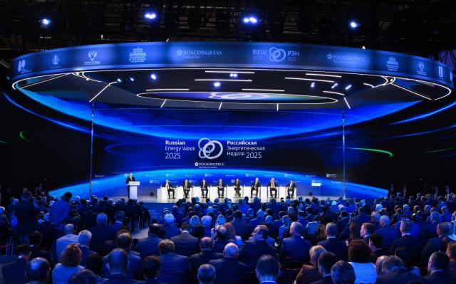 In this pool photograph distributed by the Russian state agency Sputnik, Russia's President Vladimir Putin gives a speech during a plenary session of the Russian Energy Week forum in Moscow on October 16, 2025. (Photo by Grigory SYSOYEV / POOL / AFP)