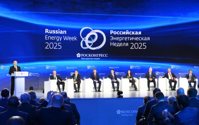 In this pool photograph distributed by the Russian state agency Sputnik, Russia's President Vladimir Putin gives a speech during a plenary session of the Russian Energy Week forum in Moscow on October 16, 2025. (Photo by Grigory SYSOYEV / POOL / AFP)