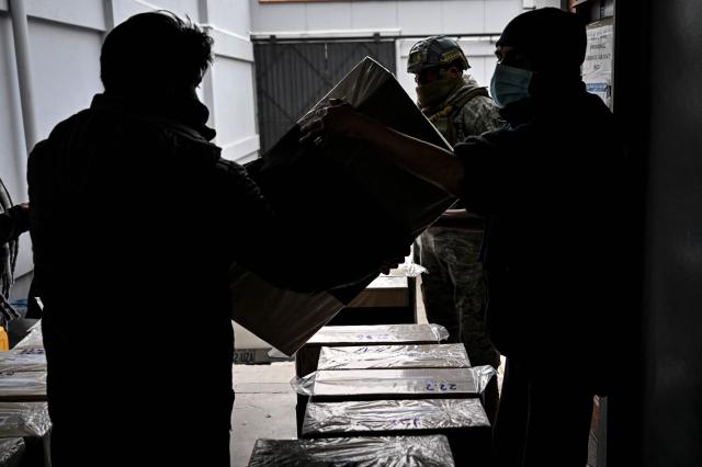 Electoral Tribunal staff members distribute electoral materials at the Electoral Logistics Distribution Center, in La Paz, on October 16, 2025. Bolivia will hold the runoff presidential election on October 19, 2025. (Photo by MARTIN BERNETTI / AFP)