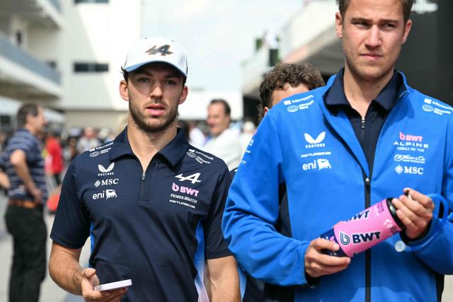 Alpine's French driver Pierre Gasly (L) walks in the paddock ahead of the United States Formula One Grand Prix at the Circuit of the Americas in Austin, Texas, on October 16, 2025. (Photo by Jim WATSON / AFP)