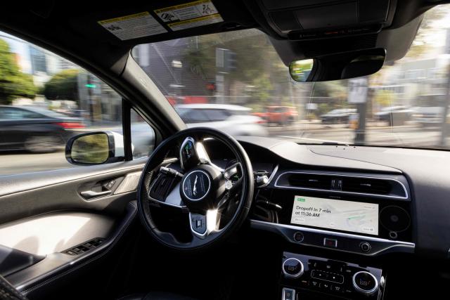 (FILES) A Waymo autonomous vehicle turns onto Octavia Street from Oak Street in San Francisco, on November 17, 2023. US food delivery app DoorDash announced October 15, 2025 that Waymo driverless cars will soon shuttle orders to some customers in a budding partnership with the Google-owned robotaxi star. The alliance will start in coming months with Waymo cars delivering take-away meals, groceries and convenience shop items to DoorDash users in the southwestern US city of Phoenix, according to the companies. (Photo by Jason Henry / AFP)