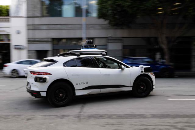 (FILES) A Waymo autonomous vehicle turning onto Mission Street in San Francisco, on November 17, 2023. US food delivery app DoorDash announced October 15, 2025 that Waymo driverless cars will soon shuttle orders to some customers in a budding partnership with the Google-owned robotaxi star. The alliance will start in coming months with Waymo cars delivering take-away meals, groceries and convenience shop items to DoorDash users in the southwestern US city of Phoenix, according to the companies. (Photo by Jason Henry / AFP)