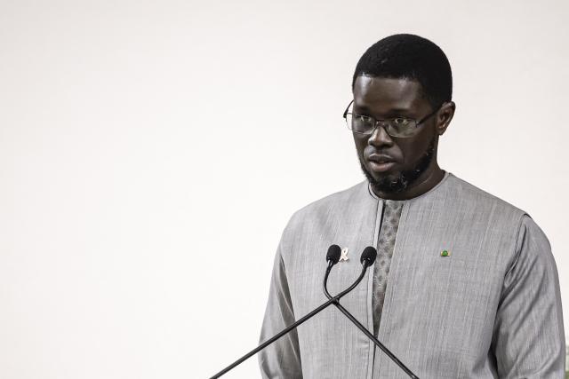 Senegal President Bassirou Diomaye Faye delivers a speech after receiving the official report on the Thiaroye massacre during a ceremony at the Presidential Palace in Dakar, on October 16, 2025. An official report commissioned by Senegal on the killing of dozens of African WWII troops by French forces in 1944 was presented to President Bassirou Diomaye Faye on October 16, 2025. The violent incident at the Thiaroye military camp just outside Dakar occurred after African soldiers who had fought for France during the war protested against pay delays. (Photo by PATRICK MEINHARDT / AFP)