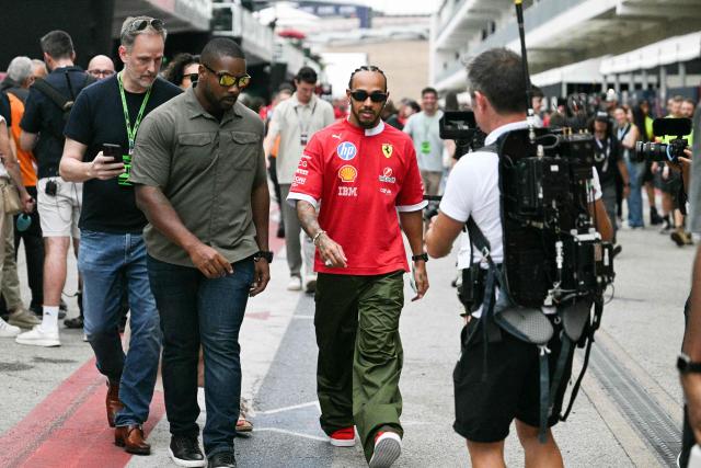 Ferrari's British driver Lewis Hamilton arrives in the paddock ahead of the United States Formula One Grand Prix at the Circuit of the Americas in Austin, Texas, on October 16, 2025. (Photo by Jim WATSON / AFP)