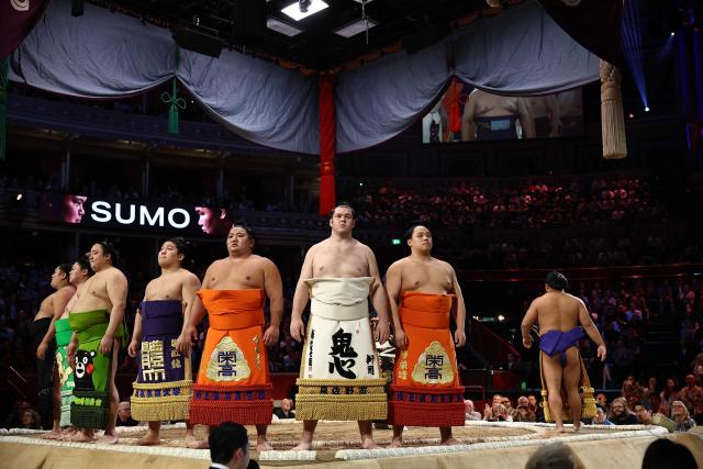 Rikishi take part in the ring entering ceremony on day 2 of the Grand Sumo Tournament at the Royal Albert Hall in central London on October 16, 2025. (Photo by HENRY NICHOLLS / AFP)