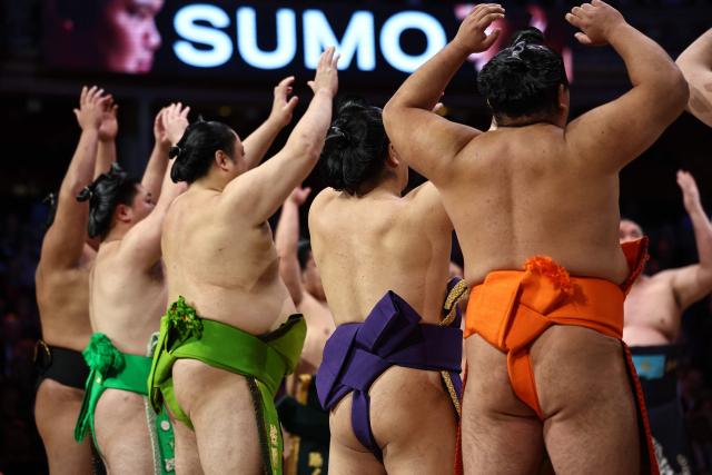 Rikishi take part in the ring entering ceremony on day 2 of the Grand Sumo Tournament at the Royal Albert Hall in central London on October 16, 2025. (Photo by HENRY NICHOLLS / AFP)